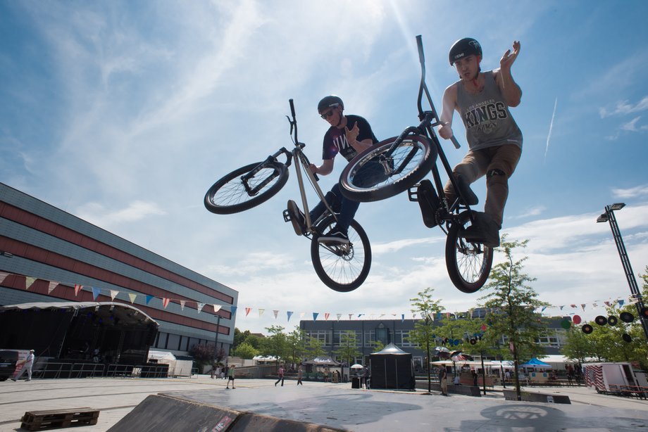 students jumping over a ramp with a BMX bike