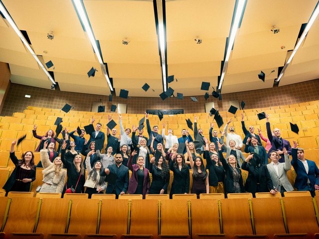 Graduates throw up their graduate hats