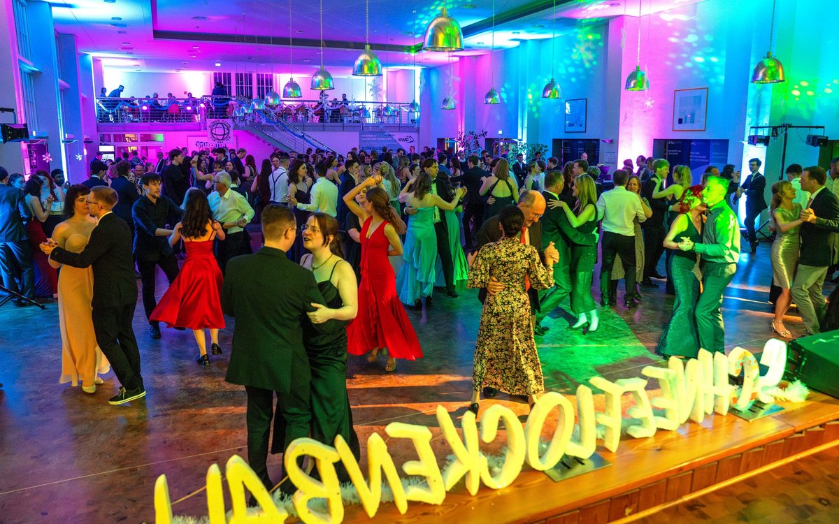 Lots of couples dancing in the hall.