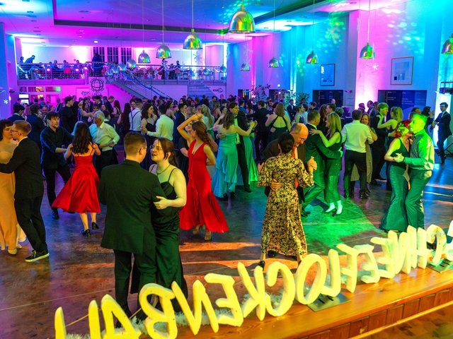 Lots of couples dancing in the hall.