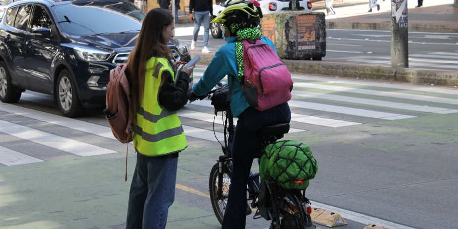 Verkehrsumfrage. Eine Frau auf dem Fahrrad und eine Interviewerin zu Fuß