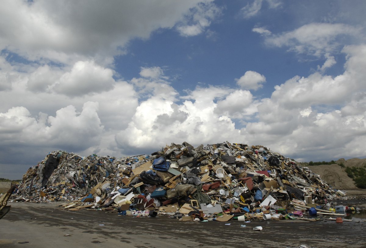 A huge pile of rubbish in an open space.
