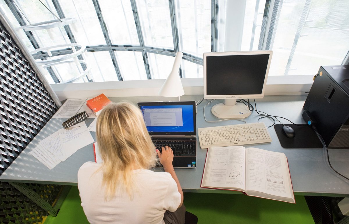 Junge Frau mit ihrem Laptop in Informations-, Kommunikations- und Medienzentrum (IKMZ)