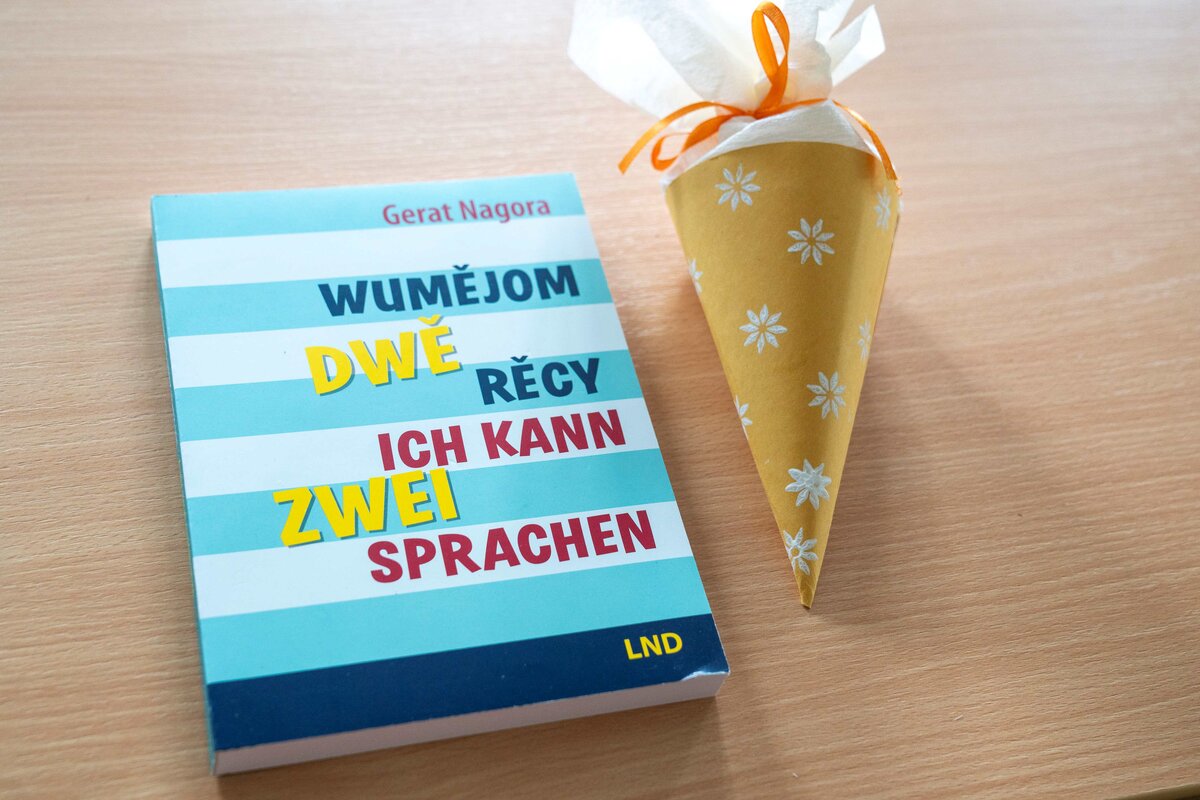 Eine Zucketüte und ein Fachbuch, die Dozentin Julia Běrink ihren Studierende zur Begrüßung jeweils überreichte.