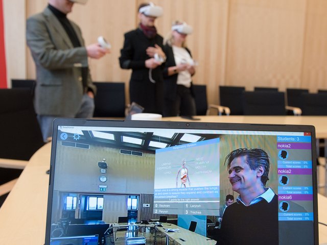 Three people with VR glasses.