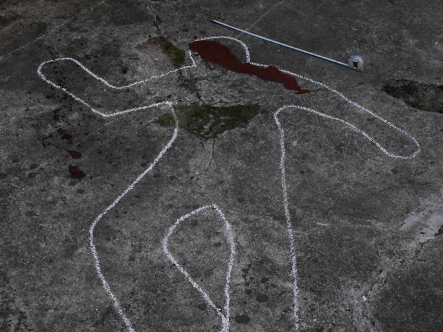 Crime scene photo - shows the outline of a lying person drawn with chalk. 