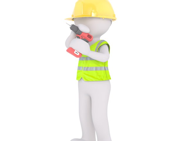 Bauarbeiterfigur mit Bohrmaschine im Arm