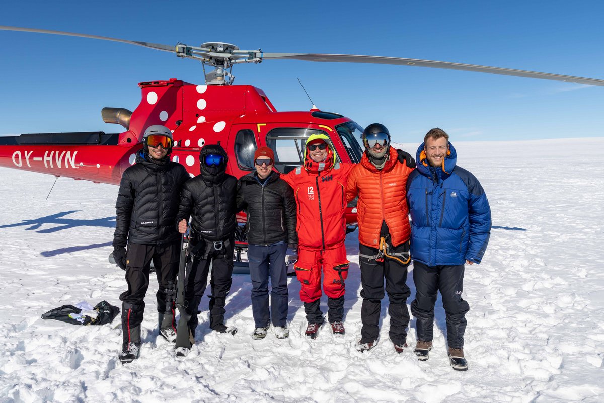 Group photo with a helicopter in the background