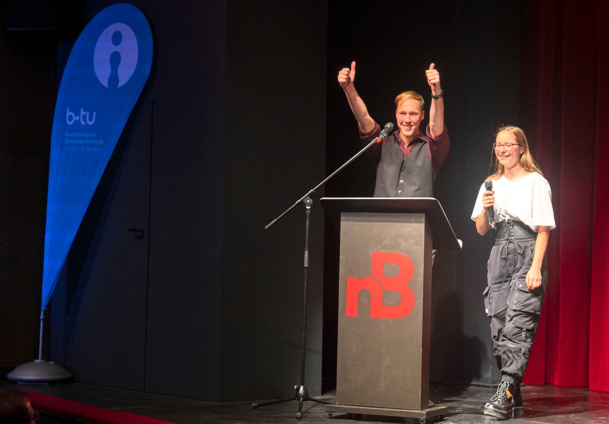 A student and a student speak at the lectern.