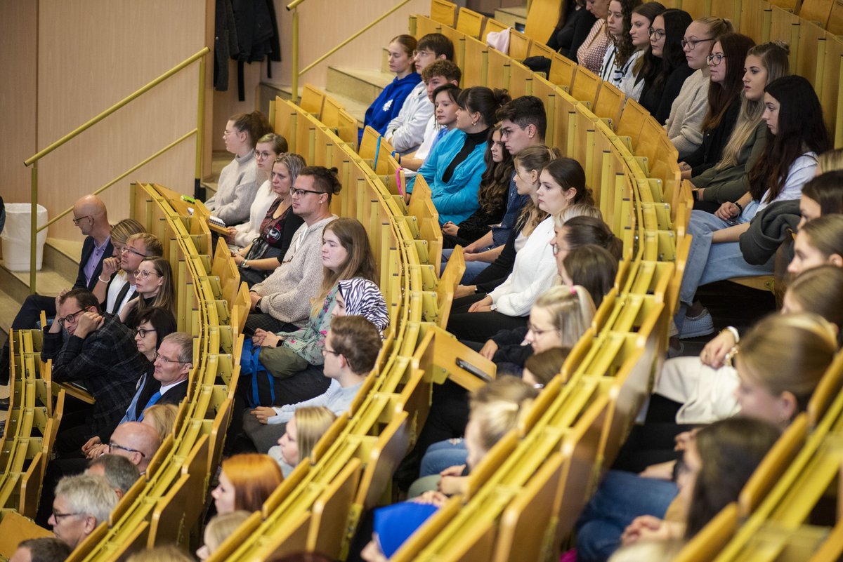 Students sit in the lecture theatre.