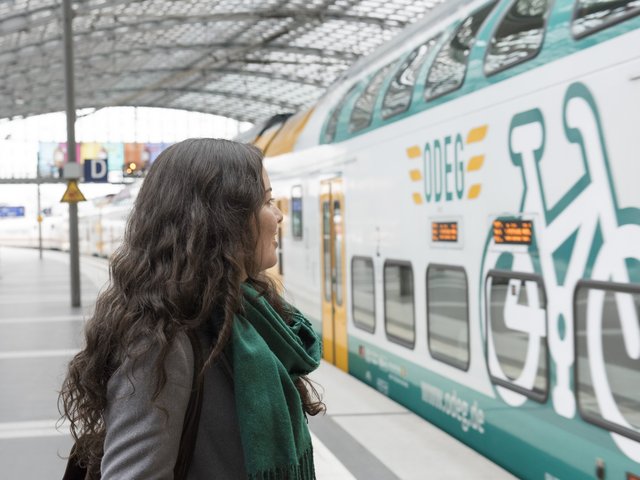 Student looking at regional express train