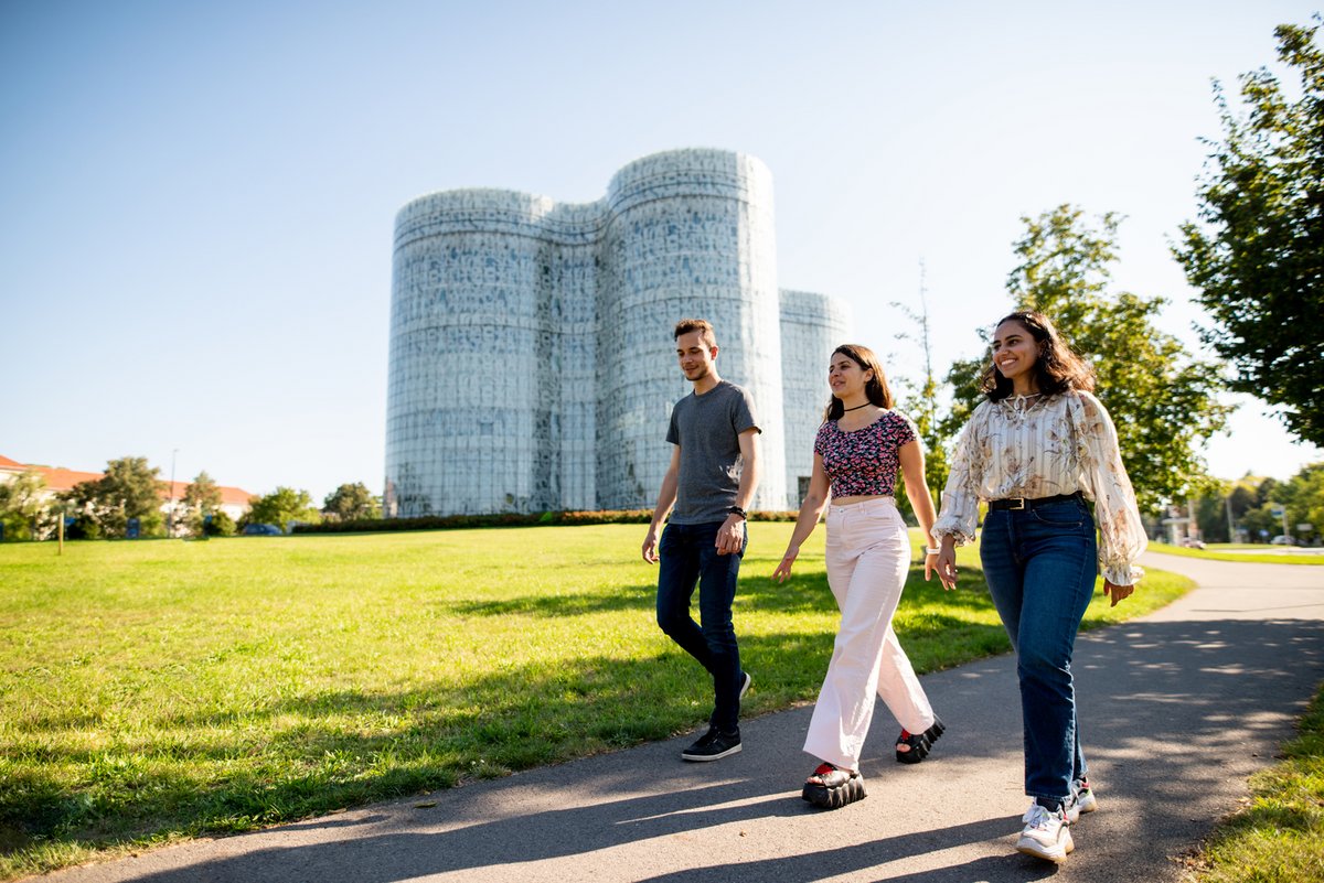 Three students in front of the Information, Communication and Media Centre BTU in Cottbus.
