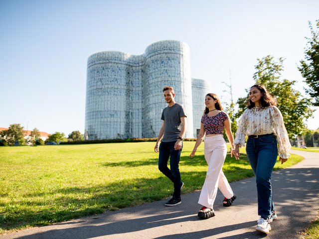 Three students in front of the Information, Communication and Media Centre BTU in Cottbus.
