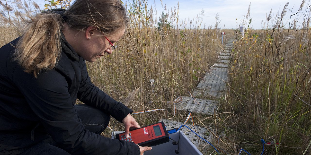 PhD student in ERM reads measurement data in the field