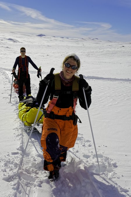 Luisa Näke on foot on the road in Hardangervidd, she pulls a sled