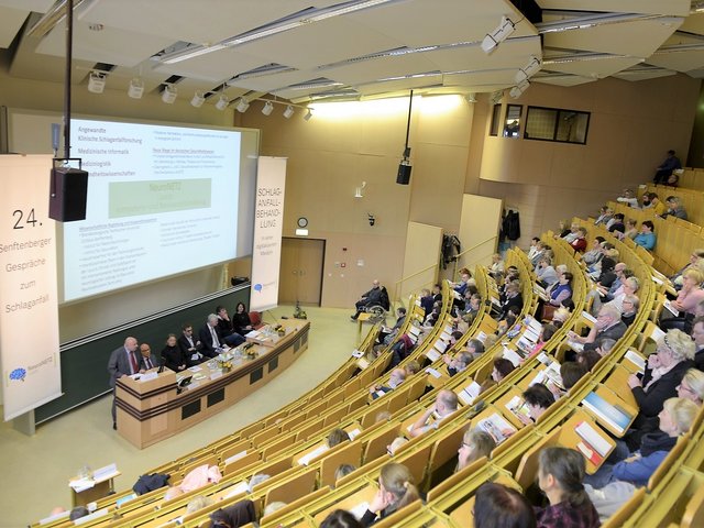 Teilnehmende der 24. Senftenberger Gespräche zum Schlaganfall 2019 sitzen im Hörsaal und folgen einer Vorlesung.