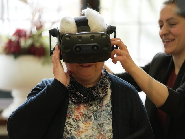 Elderly lady with VR glasses