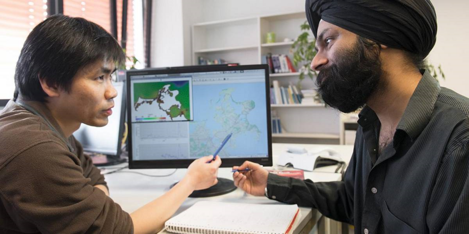 Students from different nations analyse values on the computer