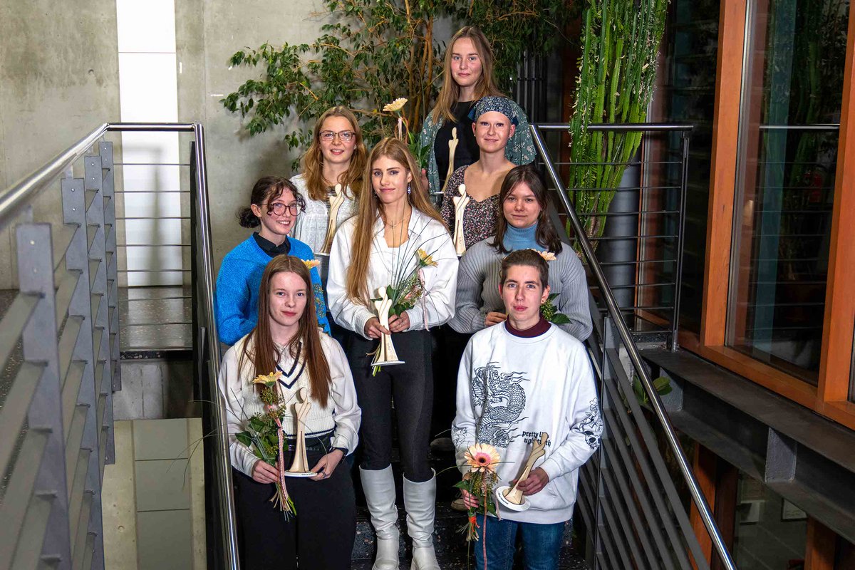 Group photo: Eight MINT women scholarship holders on a staircase.