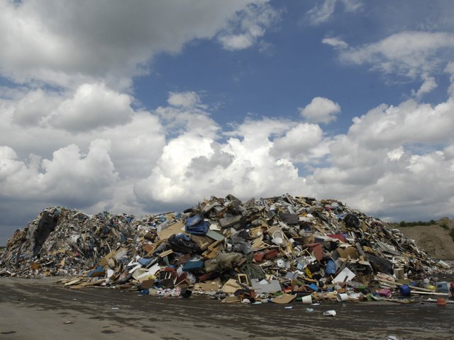 A huge pile of rubbish in an open space.