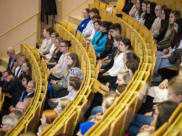 Students sit in the lecture theatre.