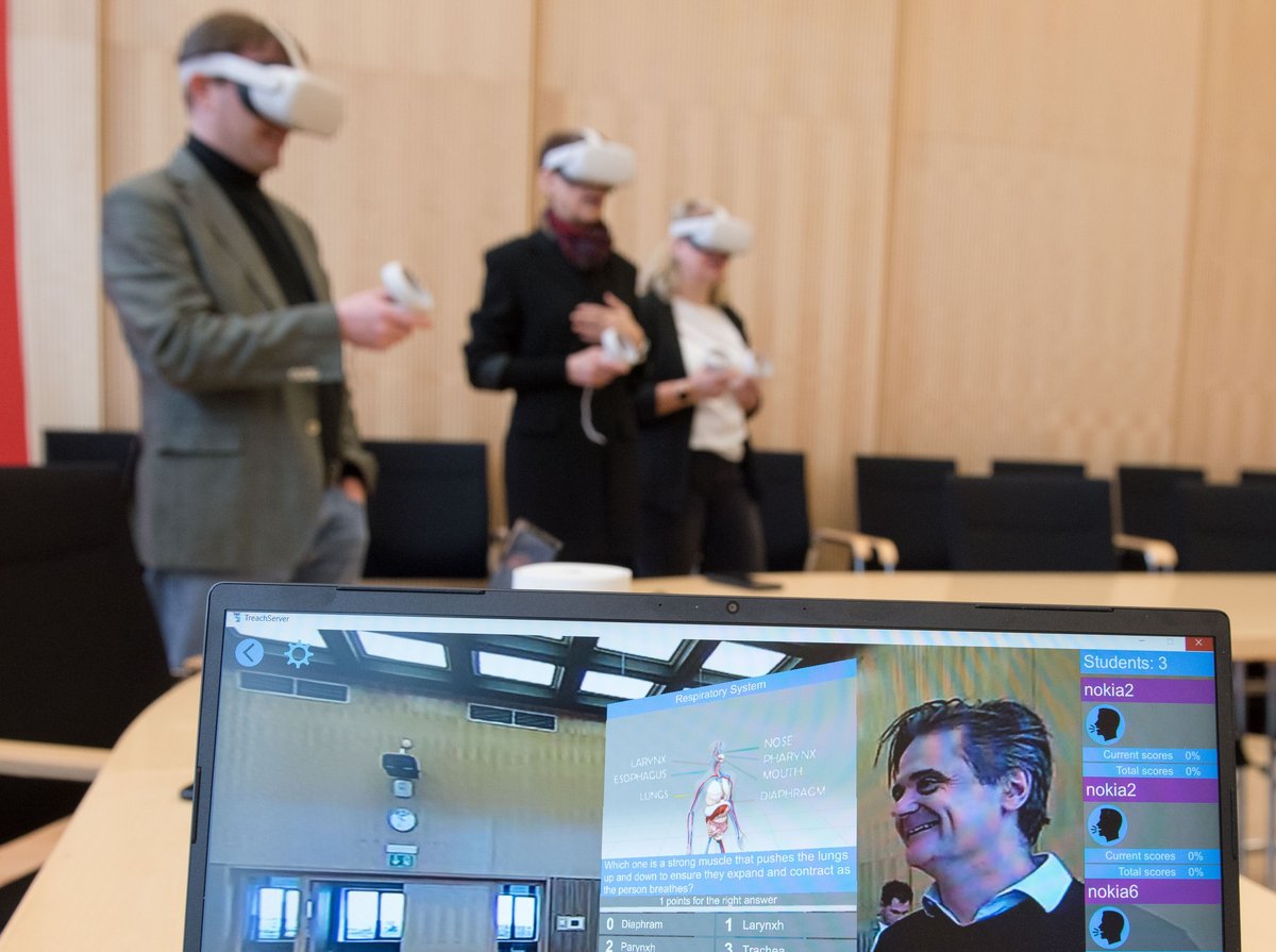 Three people with VR glasses.