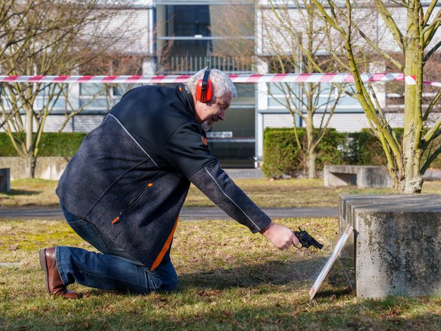 Professor Fischer shoots at the paper target from a short distance. Photo: BTU, Sascha Thor.