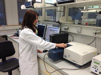 Manja Schiemann is using a photometer to quantify enzymatic hydrolysis of a substrate.