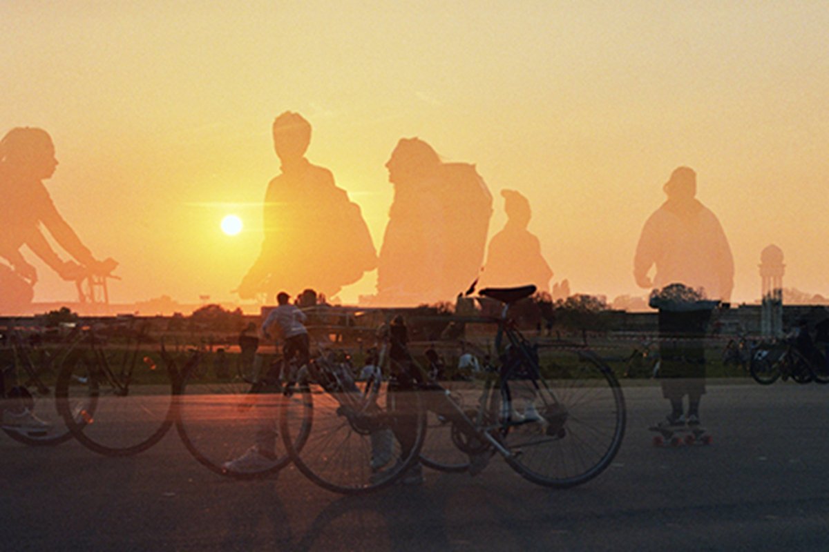 Photo of Tempelhofer Feld at sunset with cyclists in the foreground