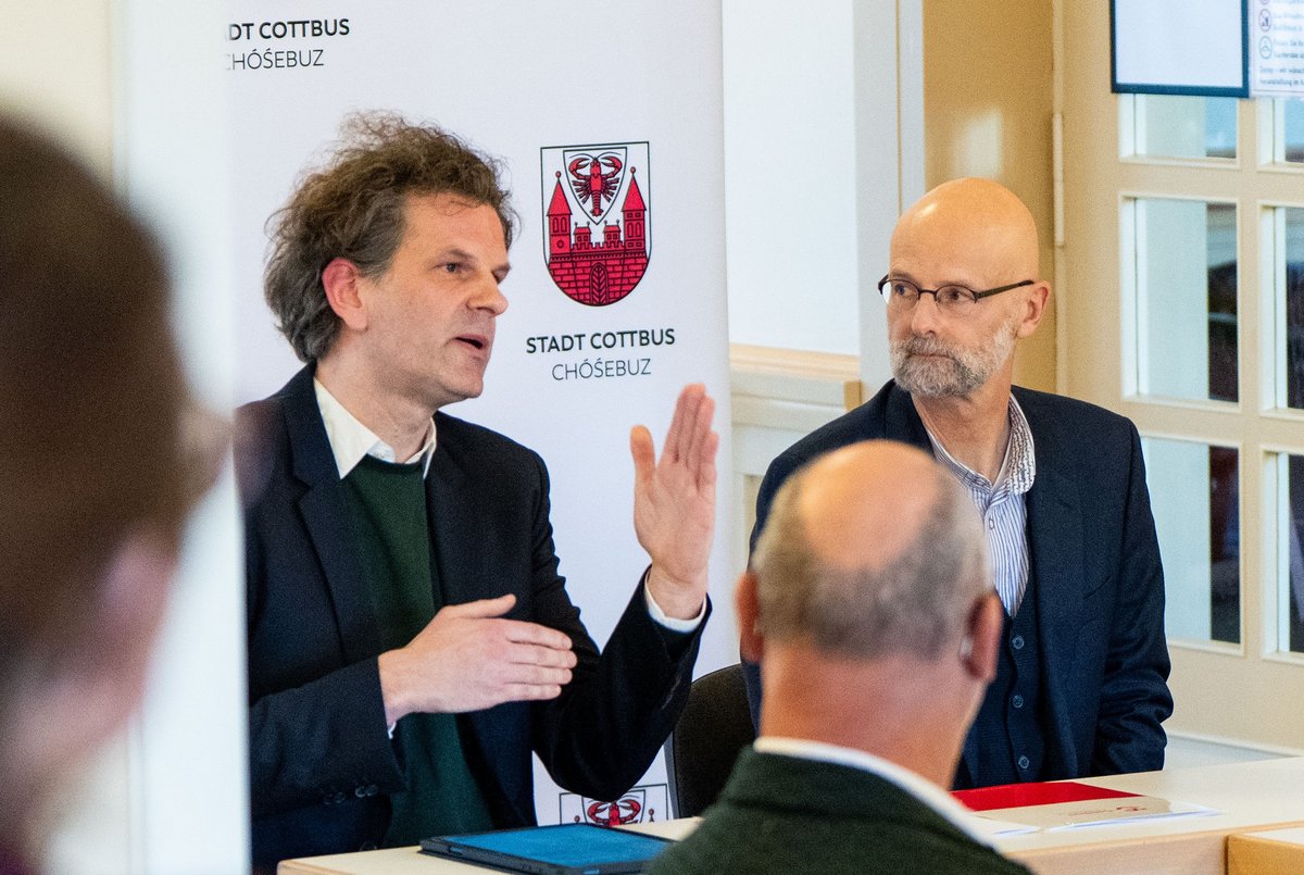 Der BTU-Vizepräsident Prof. Dr. Peer Schmidt (rechts) und Studiengangsleiter Prof. Dr. Gregor Fuhrmann geben, am Tisch sitzend, Erläuterungen.