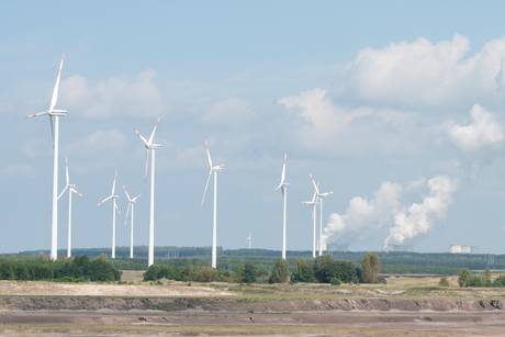 Coal-fired Power Station and wind-engines in front of a strip mining