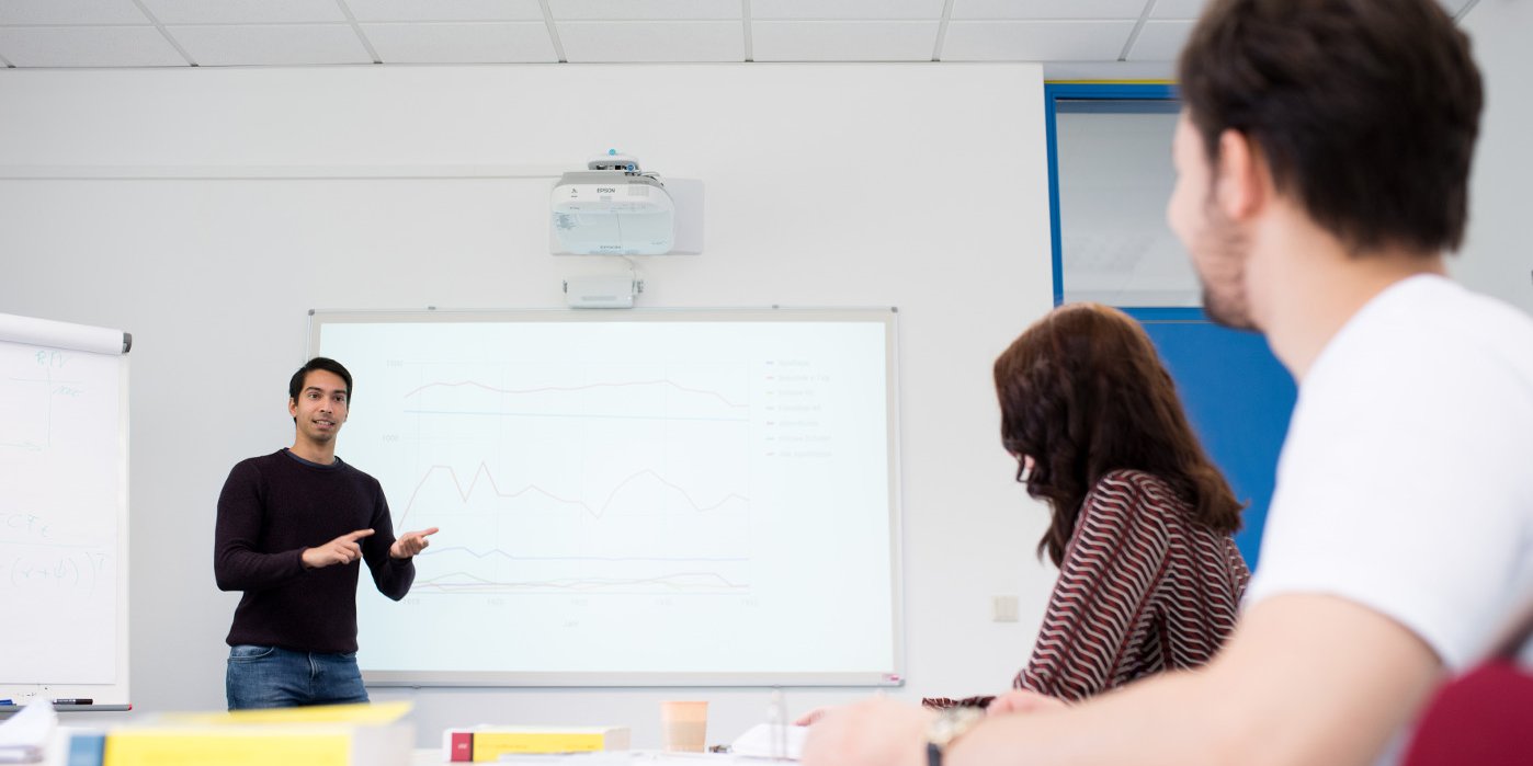 Student of business administration gives a presentation to fellow students