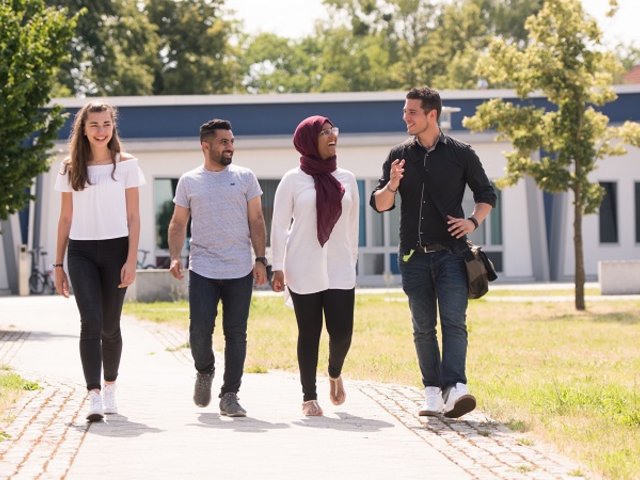 Vier Studierende laufen über den Campus. Foto: BTU, Ralf Schuster