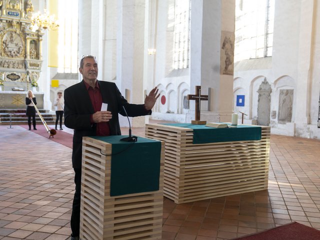 Der Künstler an den von ihm gestalteten Holzaltars