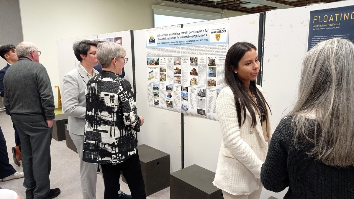 Participants of the conference view and evaluate posters.