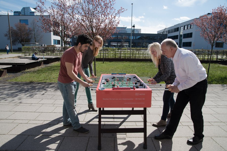 Members of the university playing table soccer