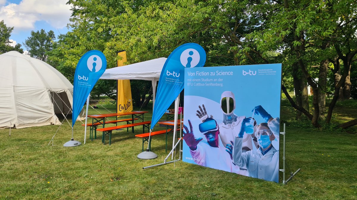 BTU booth with photo wall and tent