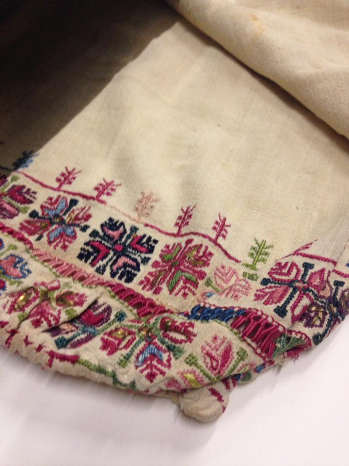 A piece of Syrian textiles (a white fabric with ornamenal stitching)