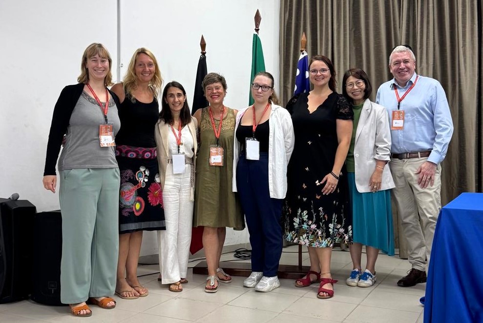 Participants of the WERA conference in front of the flags 