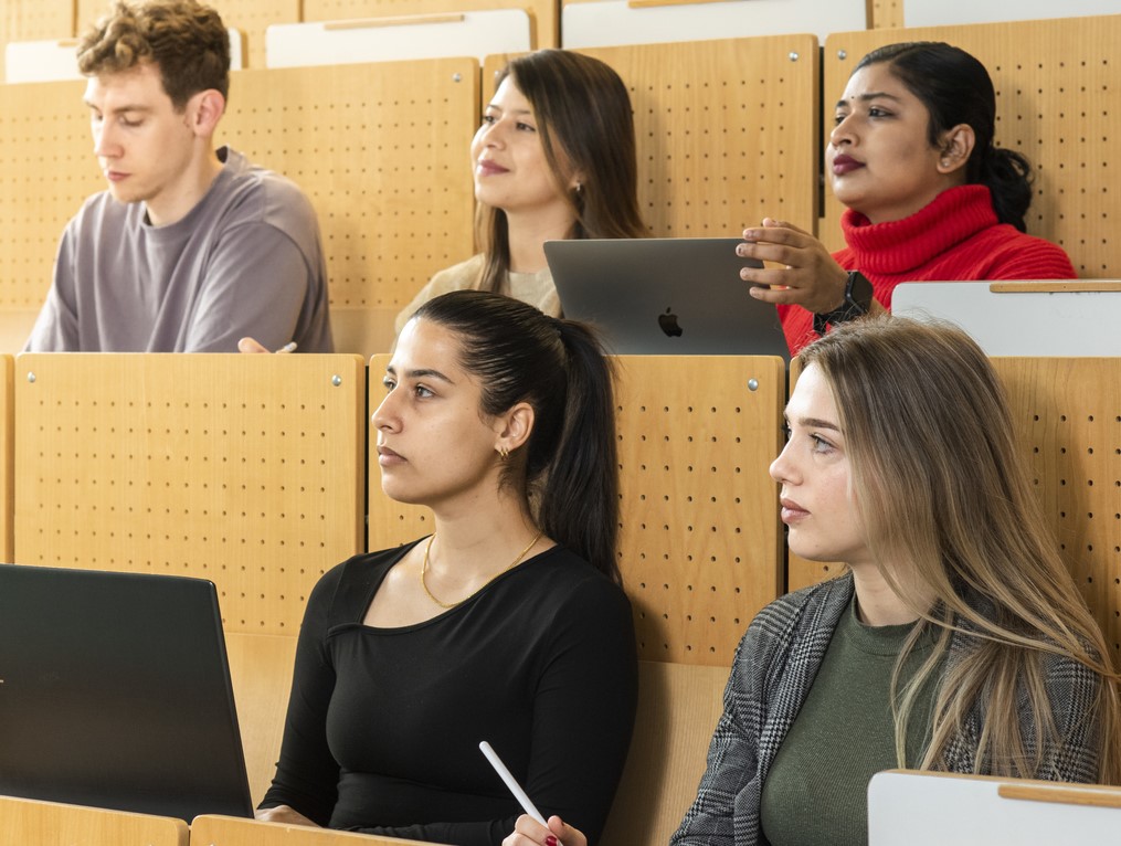 Students sit in the lecture hall.