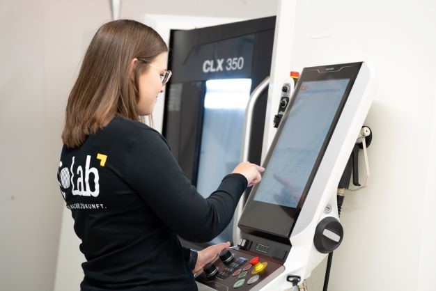 Tina Rischke in front of the CNC lathe