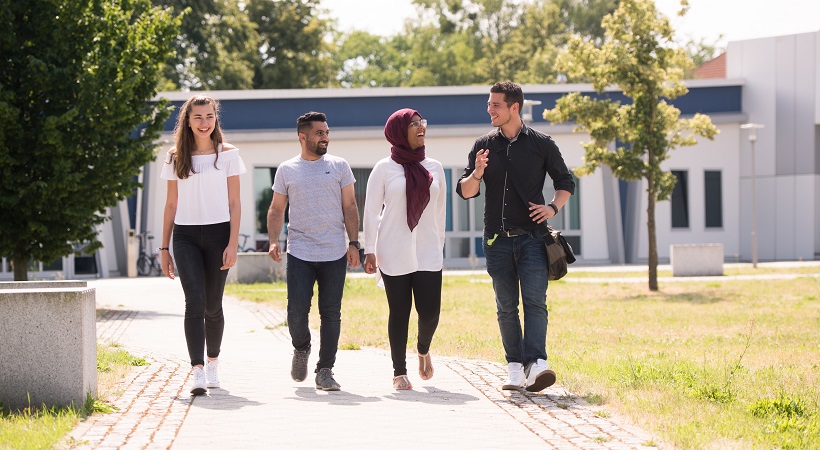 Vier Studierende laufen über den Campus. Foto: BTU, Ralf Schuster